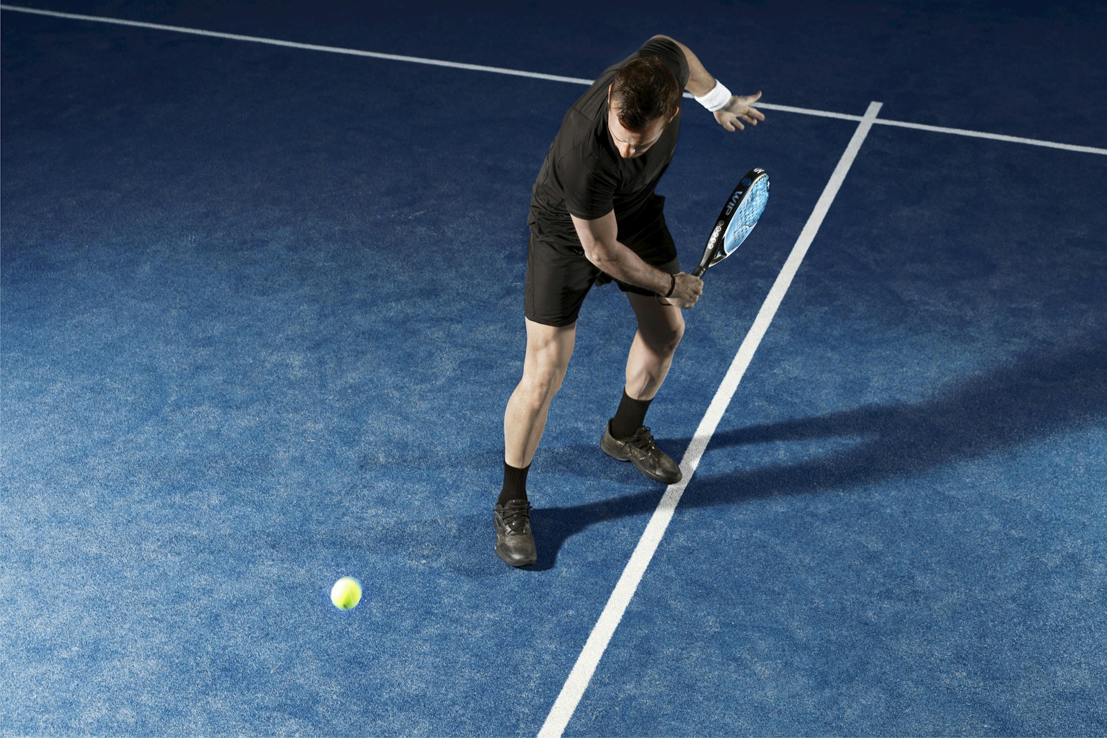 a man holding a tennis racquet on a tennis court